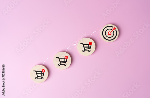 Wooden label with shopping cart icon and jumping line to target dartboard. Increase higher profit sale volume, shopping trolley cart for fast online e-commerce shipping product delivery to customer.