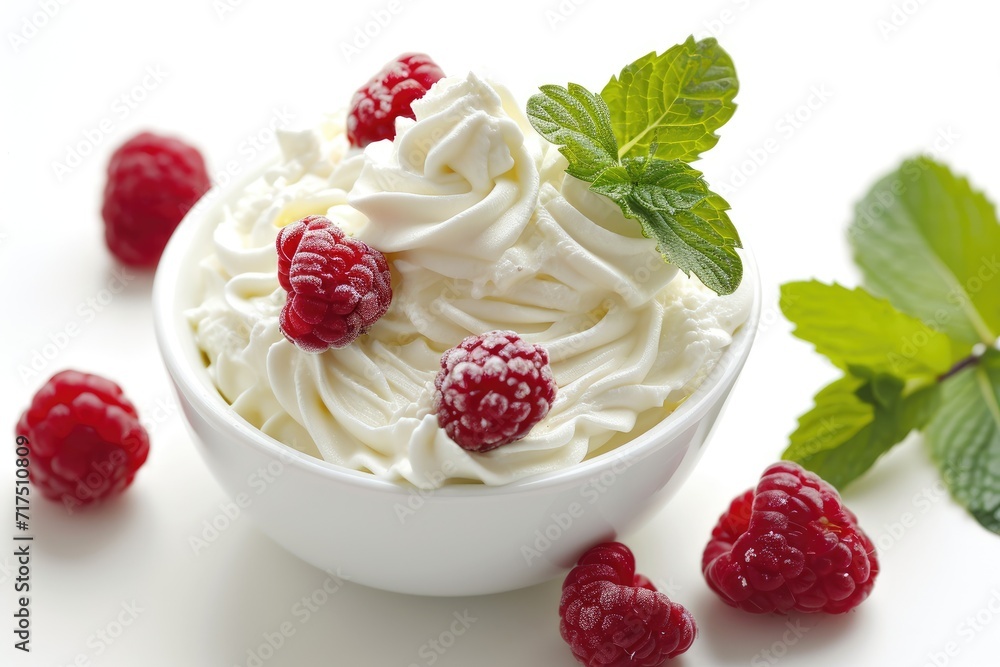 Close up of white background with bowl containing whipped cream raspberries and mint leaves Close up of white background with bowl containing whipped cream raspberries and mint leaves