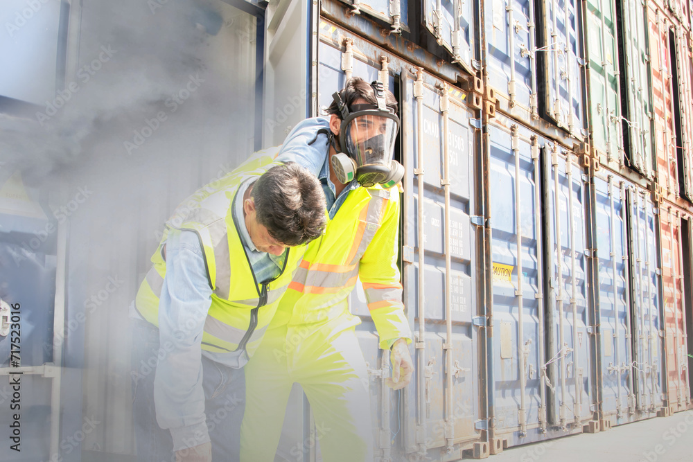 Male rescue workers PPE uniforms wearing gas mask protect against accidental leaks toxic fumes dangerous gases pungent odor keep workers unconscious safe from dangerous toxins inside container.