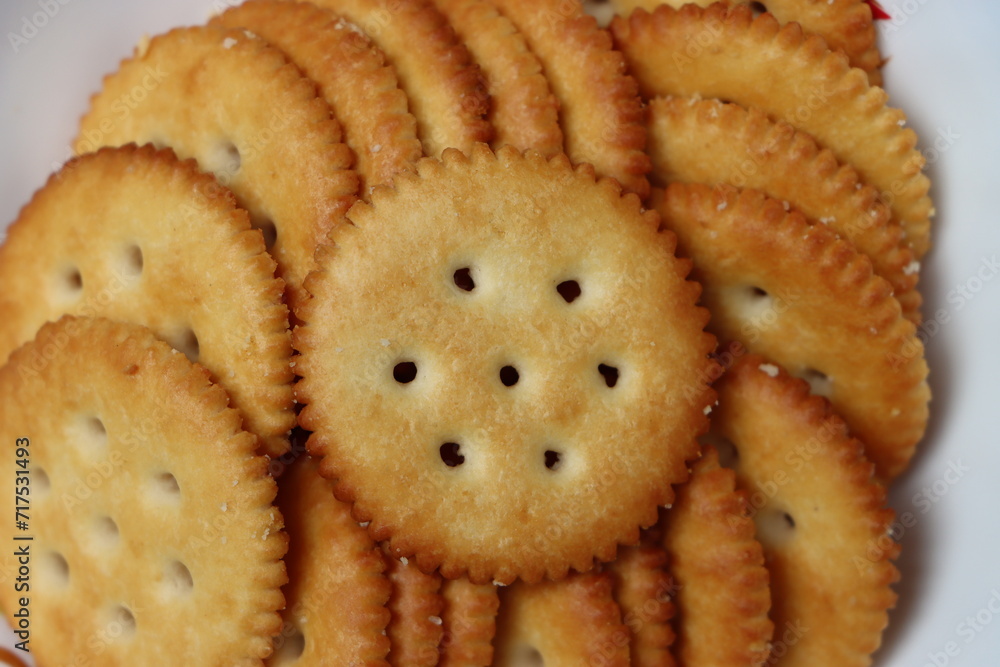 Salted crackers or biscuits served in black platter, tea time snack Salted crackers or biscuits served in black platter, tea time snack