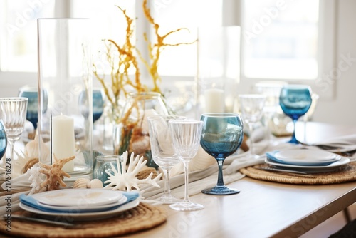 ocean themed table with blue glassware and seashell decor © studioworkstock