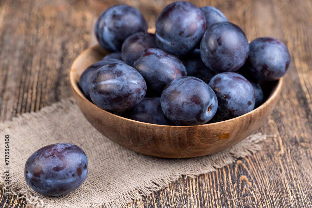 Wet purple plum on the table, fresh harvest Wet purple plum on the table, fresh harvest
