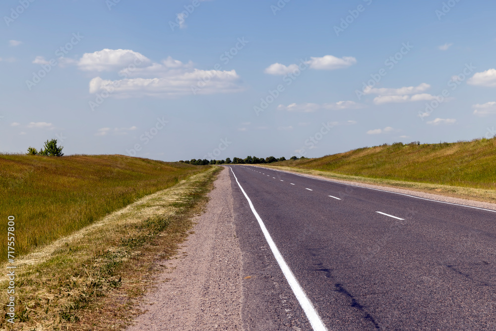 paved road along and blue sky