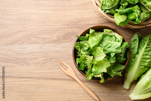 Organic cos romaine lettuce in wooden bowl, Food ingredient for healthy salad