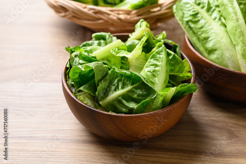 Organic cos romaine lettuce in wooden bowl, Food ingredient for healthy salad