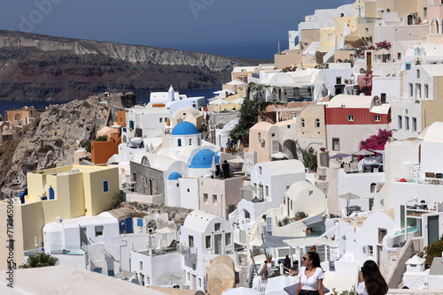 Whitewashed buildings on the edge of the caldera cliff in Oia village, Santorini, Greece