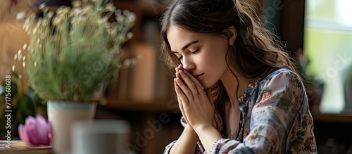 God worship and woman praying in her living room for hope help or spiritual guidance in her home Hands pray and Christian female in prayer for blessing grace and gratitude to Jesus Christ © Gular
