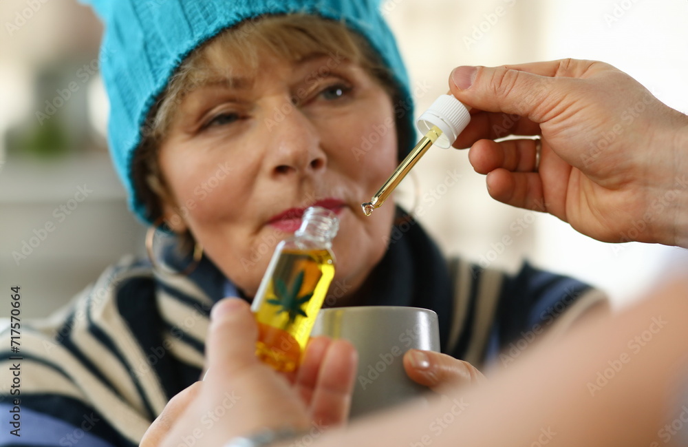 Sick elderly woman at home takes drops cannabis cup. Side effects drugs. Cold medicine for elderly. Weak immune system in old age. Use the drug in therapeutic doses. Danger to elderly Sick elderly woman at home takes drops cannabis cup. Side effects drugs. Cold medicine for elderly. Weak immune system in old age. Use the drug in therapeutic doses. Danger to elderly