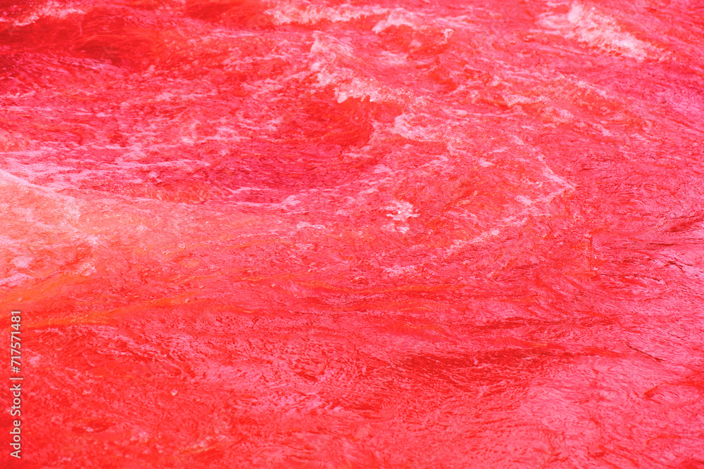 Red water background. Red water splashes on the surface ripple blur ...