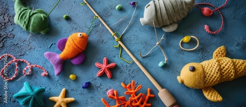 Hand made stuffed felt toy Fishing rod with magnet and fishes or other sea animals Different colors Safe eco stuffed toy for infants and toddlers Early education implement. Copy space image photo