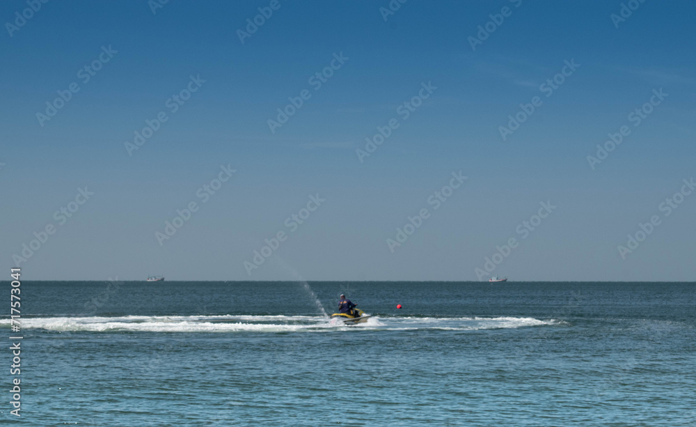 A man riding a jet ski on the beach in the Gulf of Mexico. embodying the essence of a thrilling summer water sport adventure by the coast.