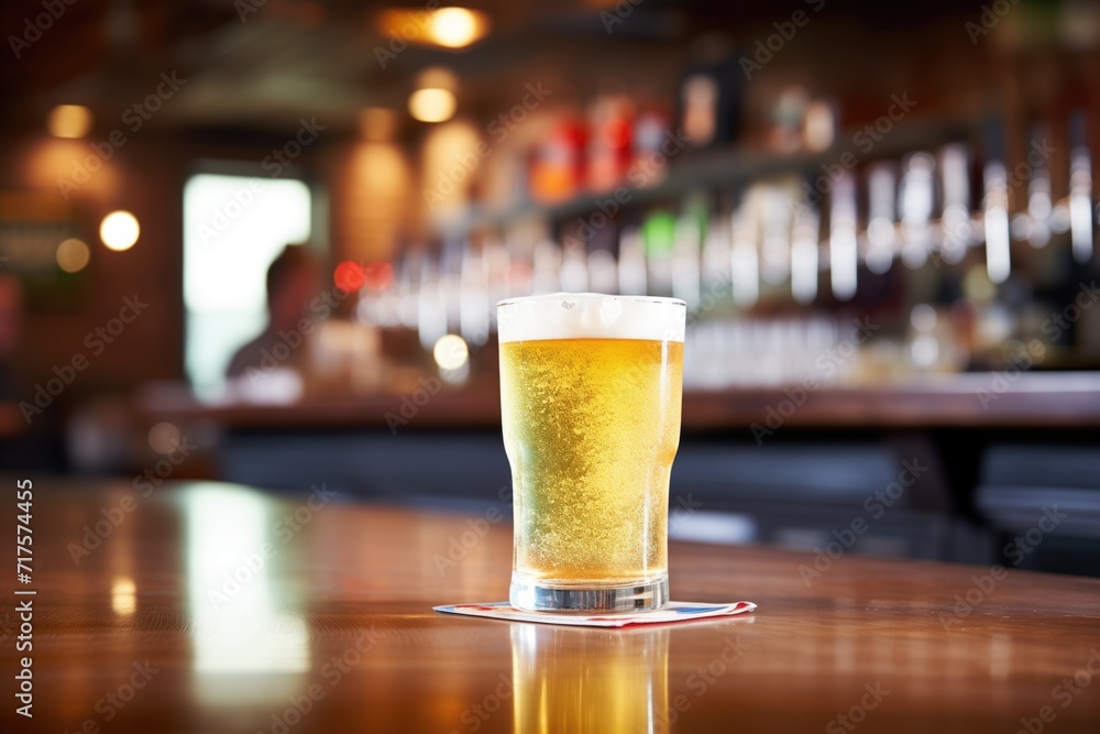 chilled light lager in glass, condensation, bar counter chilled light lager in glass, condensation, bar counter