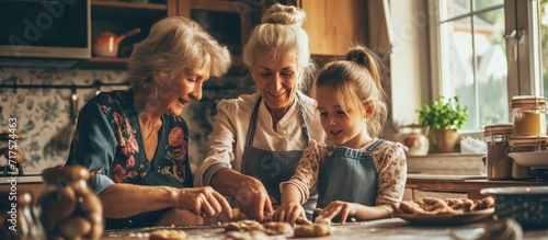 Funny head shot portrait happy three generations of women cooking sweet homemade cookies having fun with dough cute little girl with mature grandmother and mother spending leisure time together