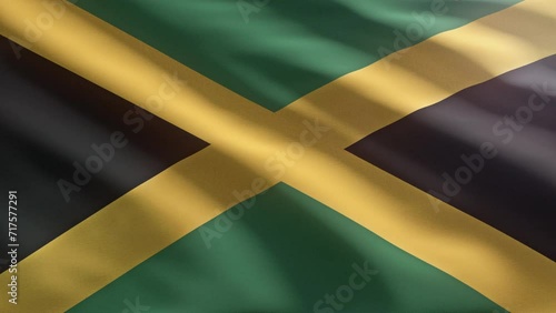 Fluttering the colourful national flag of Jamaica. Displaying the national flag of a country of Jamaica. Shaking the national flag of Jamaica with a golden cross separating green and black triangles. photo