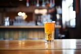 tall glass of orange soda on bar