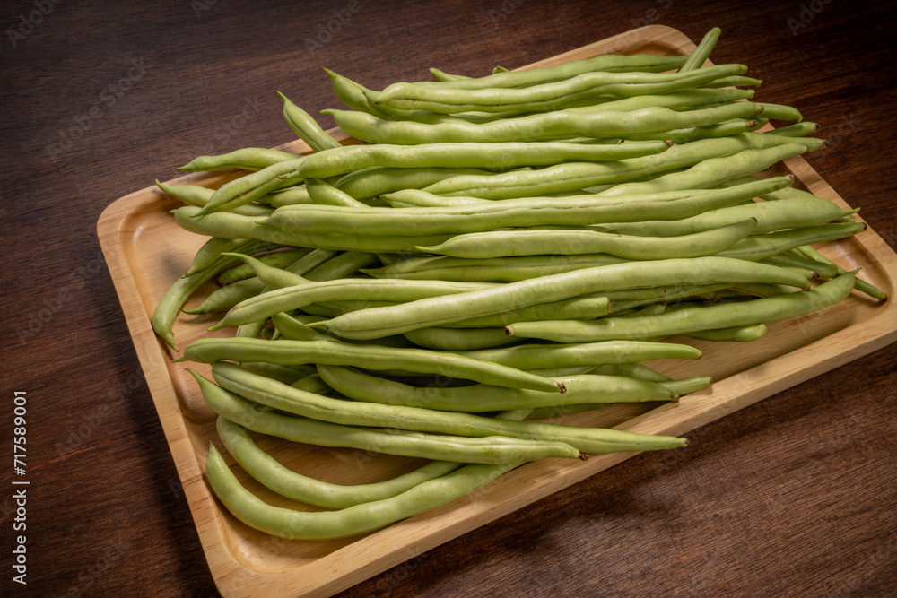 Green bean or Green pea in wooden plate on wooden background, French Bean or Green bean in wooden basket on wooden table. Green bean or Green pea in wooden plate on wooden background, French Bean or Green bean in wooden basket on wooden table.