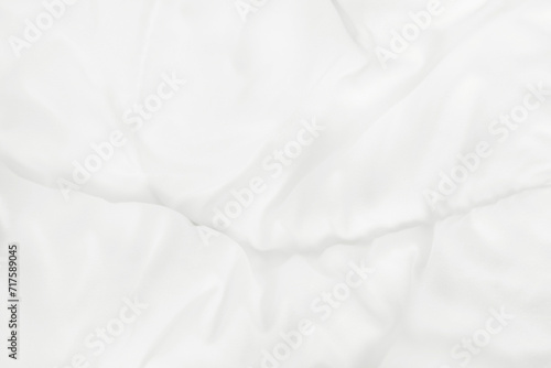 Close up top view of white bedding sheet and wrinkle messy blanket in bedroom after wake up in the morning.
