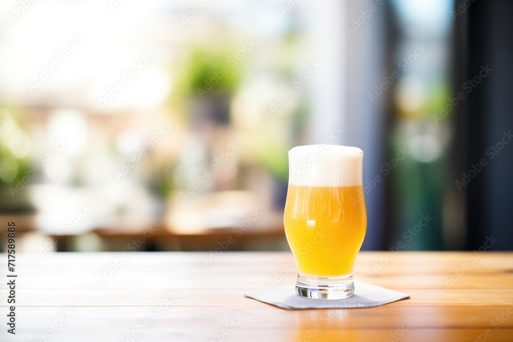 saison beer in a glass with a frothy head saison beer in a glass with a frothy head