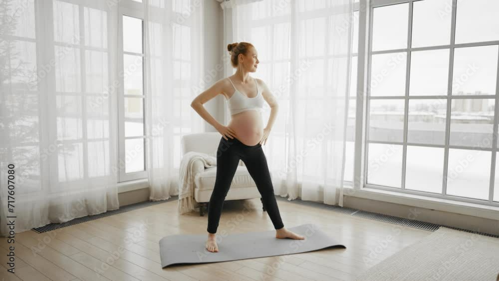 Pregnant woman doing pilates at home. Pregnant female doing yoga practice stretching with online lesson video trainer at home. Mother and child health relax and meditation practices concept. Pregnant woman doing pilates at home. Pregnant female doing yoga practice stretching with online lesson video trainer at home. Mother and child health relax and meditation practices concept.