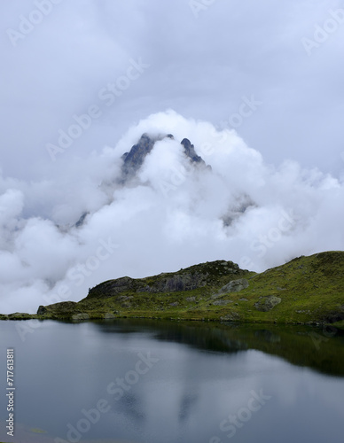 Midi dOssau peak. Nightfall between clouds in the Ayous Lakes with the Midi dOssau mountain in the background, Pyrenees National Park, France.