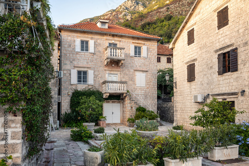 Beautiful view of an old stone house on the main promenade along the sea in the picturesque town of Perast  Bay of Kotor  Montenegro