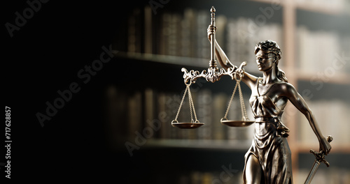 Legal Concept: Themis is the goddess of justice as a symbol of law and order on the background of books photo