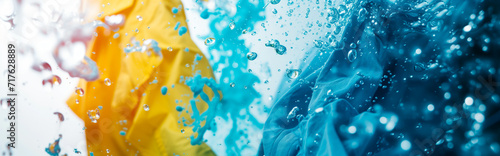 Vibrant colored detergent and water splash. Concept of laundry day and washing clothes. 
