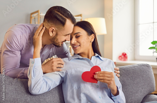 Happy smiling people in love close to kiss, giving red paper heart, sharing special romantic moment. Valentine day emotion, family couple in happiness, lover pair trust, respect between partners © Studio Romantic