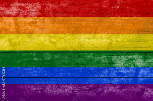 LGBT flag on a wooden surface. Banner of the grunge LGBT flag.