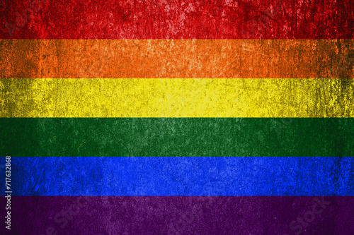 Close-up of the grunge LGBT flag. Dirty LGBT flag on a metal surface.