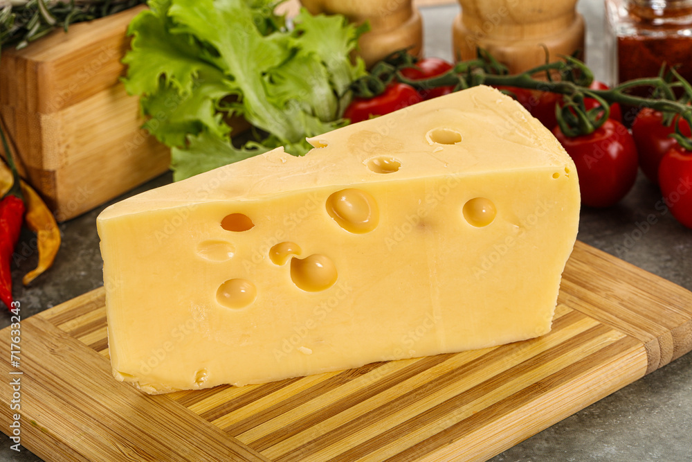 Swiss Maasdam cheese triangle over board Swiss Maasdam cheese triangle over board