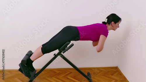 Wallpaper Mural Young woman exercising on a bench for back hyperextension, Video Clip 4K Torontodigital.ca