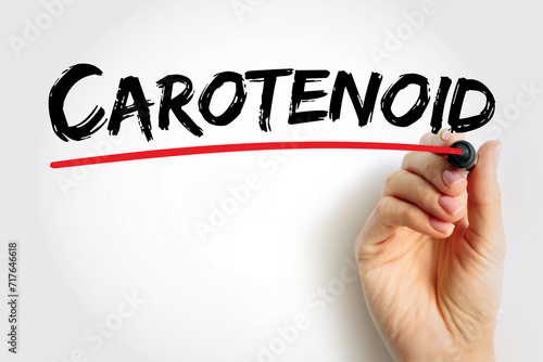 Carotenoid - tetraterpene pigments, which exhibit yellow, orange, red and purple colors, text concept background photo