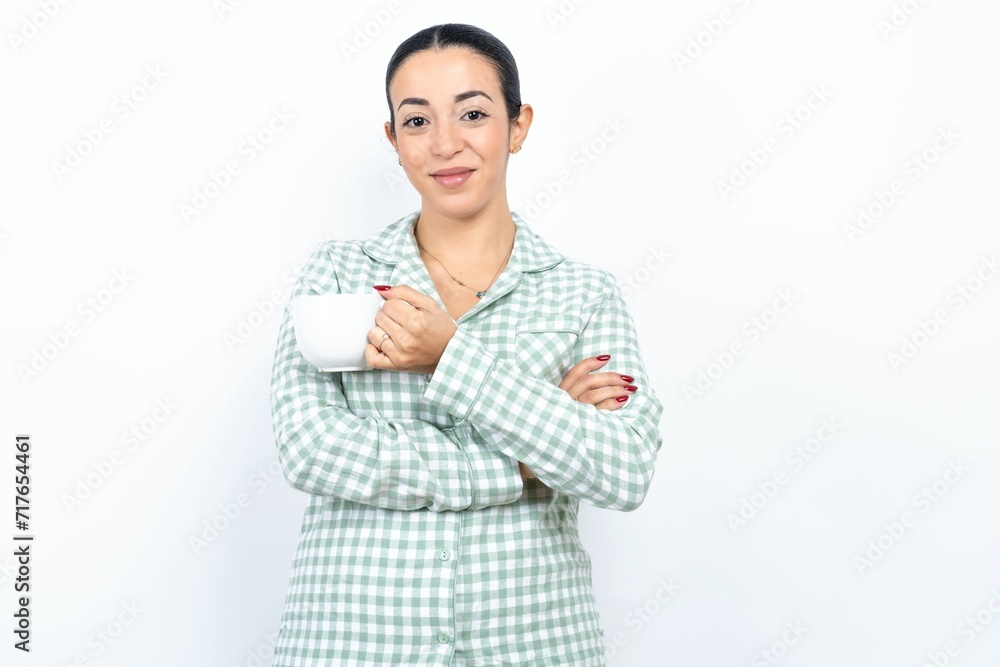 Dreamy rest relaxed Beautiful young woman wearing green plaid pyjama and holding a cup crossing arms, Dreamy rest relaxed Beautiful young woman wearing green plaid pyjama and holding a cup crossing arms,