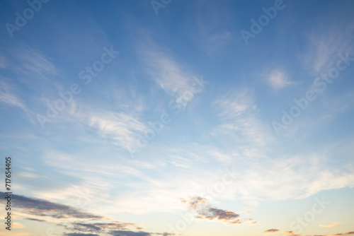 A beautiful sky tinted by the sun leaving vibrant shades of gold, pink, blue and multicolored. Clouds in the twilight evening and morning sky. Cloudy sky background in the evening and during the day.