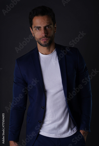 Handsome gentleman donning a sleek navy blue suit. Captured in a studio setting