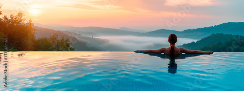 woman in the pool looks at the mountains. Selective focus.