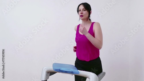 Young woman exercises and keeps fit on a treadmill at home, Video Clip 4K