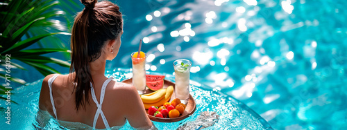 woman in the pool with fruit and cocktail. Selective focus. photo
