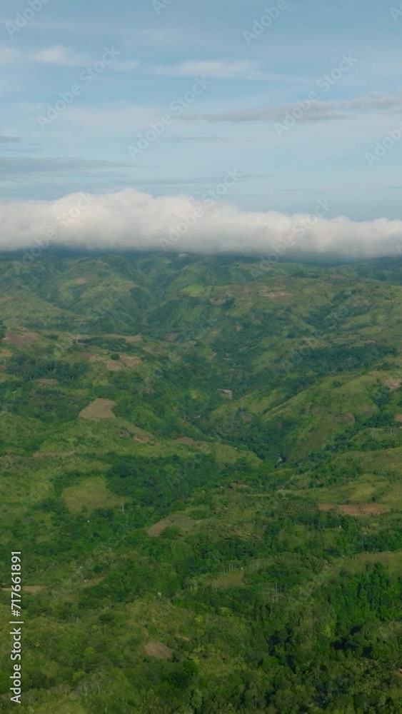 Mountain range with rainforest. Blue sky and clouds. Mindanao, Philippines. Vertical view. Mountain range with rainforest. Blue sky and clouds. Mindanao, Philippines. Vertical view.