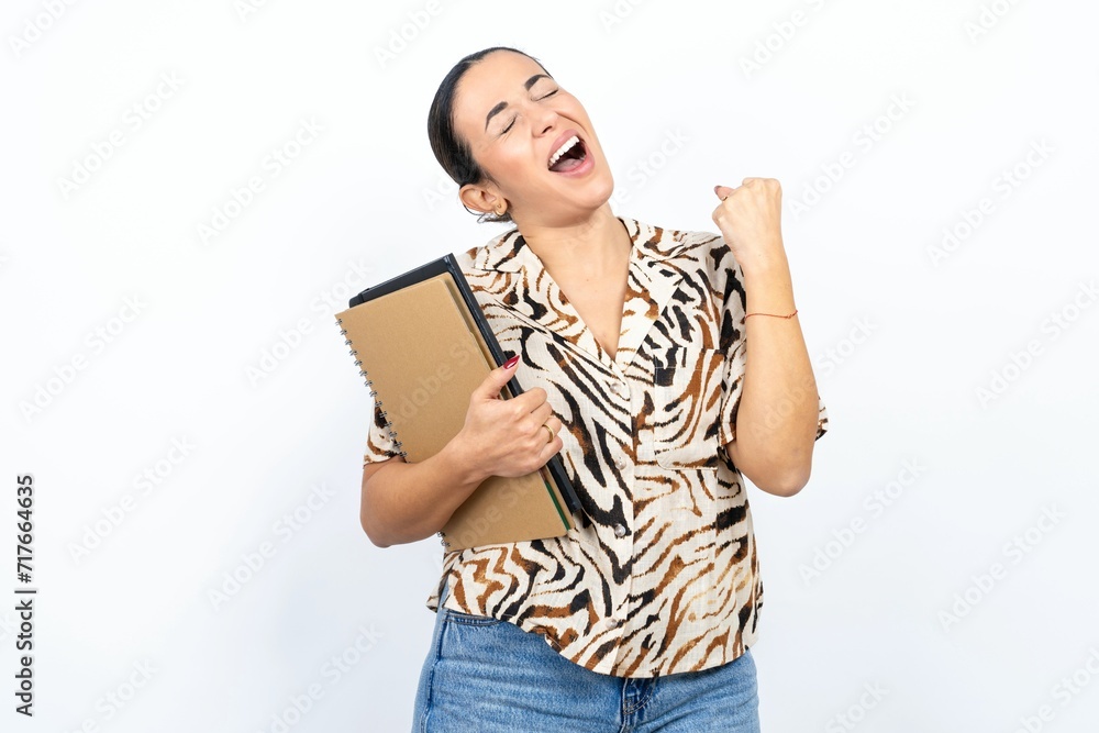 Beautiful young woman celebrating surprised and amazed for success with arms raised and eyes closed. Winner concept. Beautiful young woman celebrating surprised and amazed for success with arms raised and eyes closed. Winner concept.