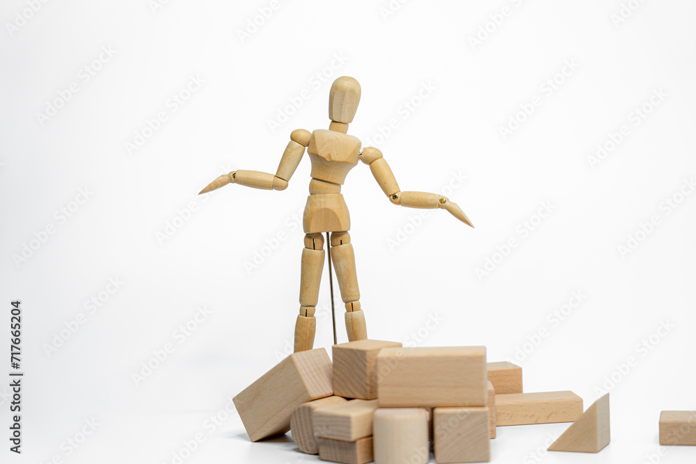 Wooden doll with wooden toy block isolated on white background. business or creative concept Wooden doll with wooden toy block isolated on white background. business or creative concept