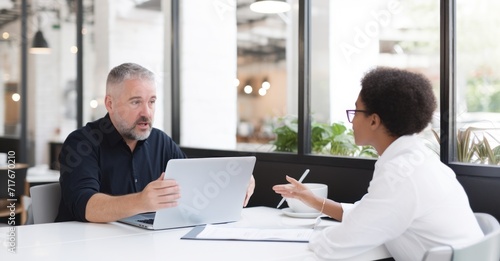 Passionate mentorship meeting in a lively coffee shop, with focused interaction and note-taking.