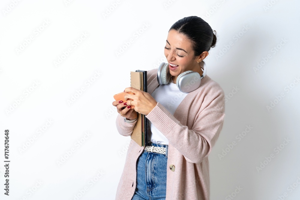 Young beautiful woman holding in hands cell playing video games or chatting Young beautiful woman holding in hands cell playing video games or chatting