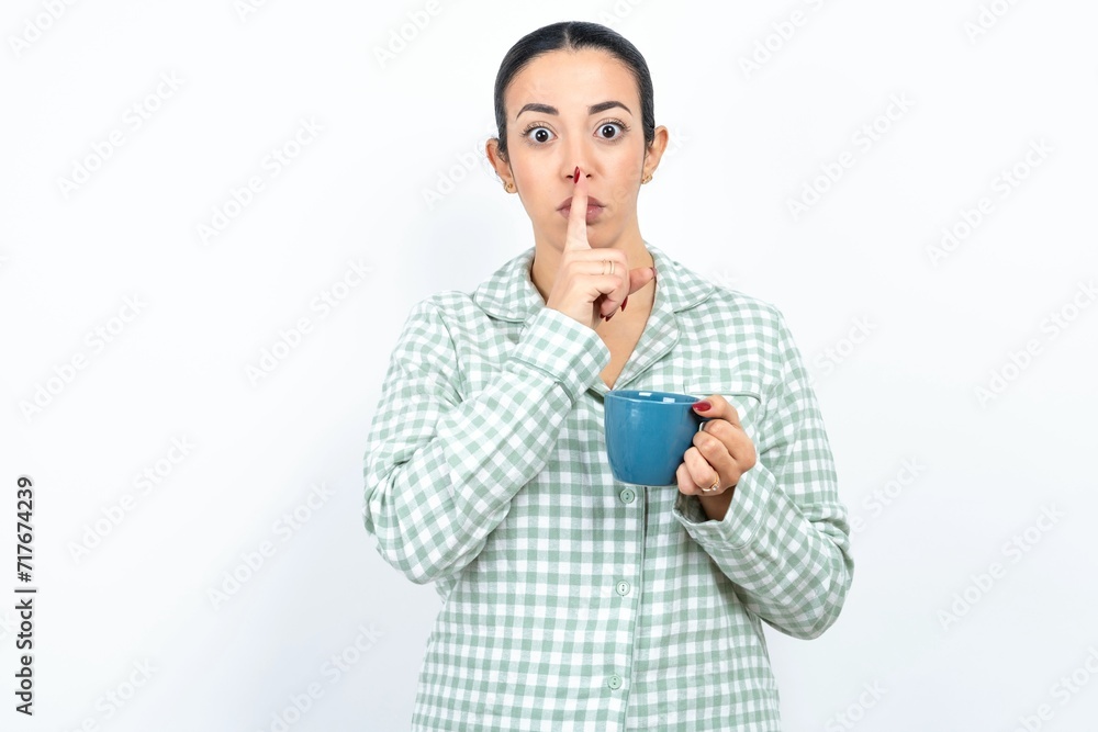 MODEL silence gesture keeps index finger to lips makes hush sign. Asks not to share secret MODEL silence gesture keeps index finger to lips makes hush sign. Asks not to share secret