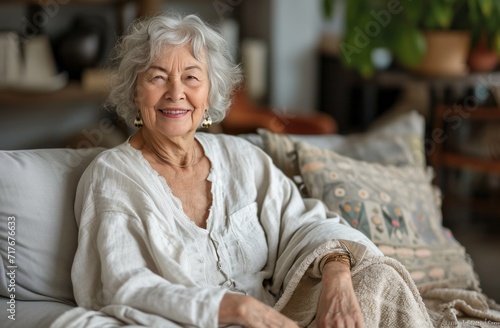 a smiling elderly woman sitting on a couch
