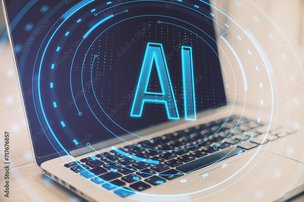 Close up of laptop computer on desk with glowing round AI hologram on ...