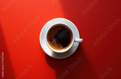 a cup with coffee on red background photo