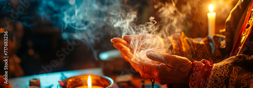 Fortune teller tells fortunes with candles and smoke. Selective focus. photo