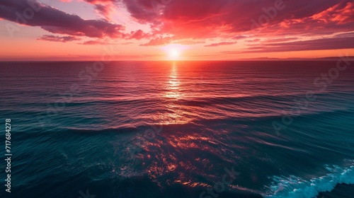 Spectacular sunset over a calm ocean horizon with vibrant colors from above. generative ai © Khalif